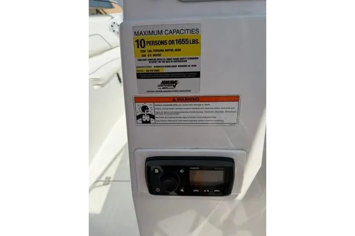 Slide: The Image of 2008 Sea Pro 228 Dual Console boat capacity label and control panel. - 34