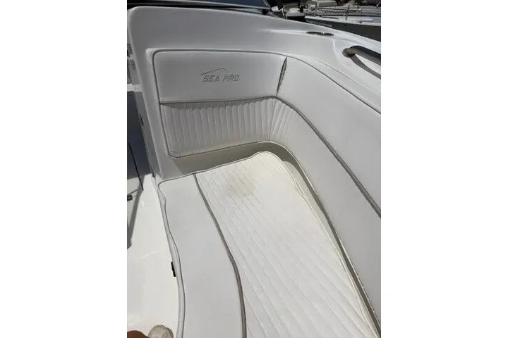 Slide: The Image of 2008 Sea Pro 228 Dual Console boat interior with white cushioned seating. - 15
