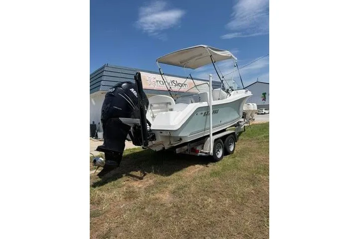 Slide: The Image of 2008 Sea Pro 228 Dual Console boat on trailer, parked outdoors under clear sky. - 10