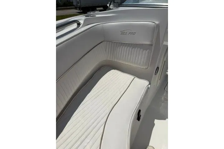 Slide: The Image of 2008 Sea Pro 228 Dual Console boat interior with white cushioned seating. - 14
