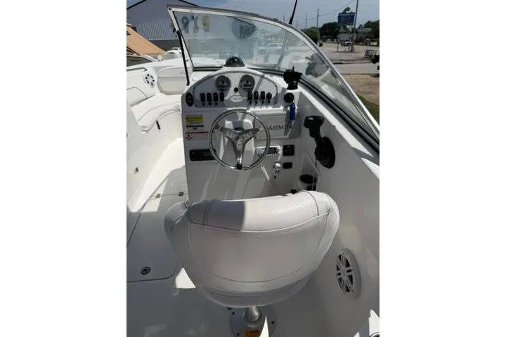 Slide: The Image of 2008 Sea Pro 228 Dual Console boat cockpit with steering wheel and dashboard controls. - 28