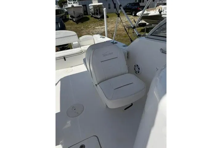Slide: The Image of 2008 Sea Pro 228 Dual Console boat interior with white seating and deck. - 17