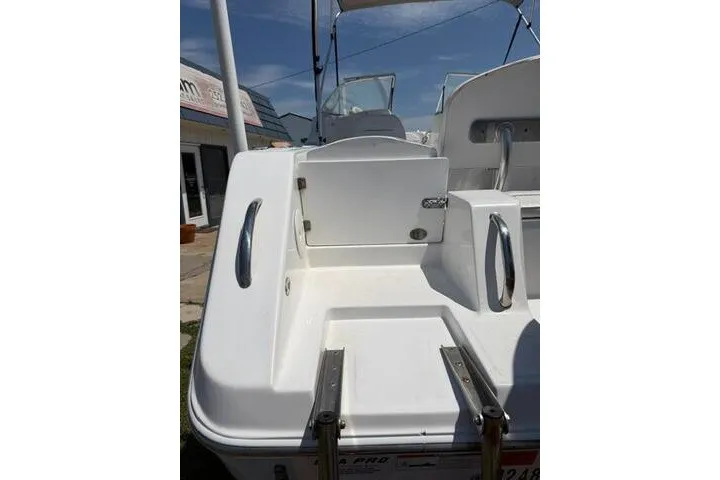 Slide: The Image of 2008 Sea Pro 228 Dual Console boat, rear view with ladder and seating area. - 11