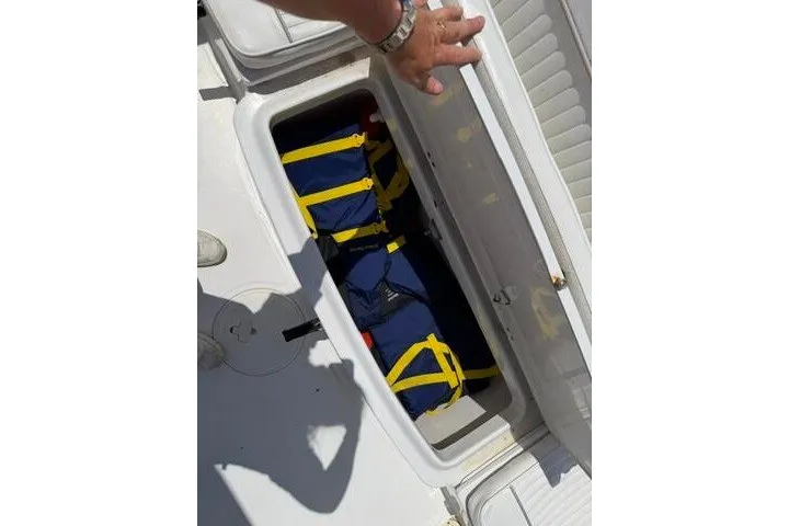 Slide: The Image of Storage compartment on a 2008 Sea Pro 228 Dual Console boat with life jackets inside. - 25