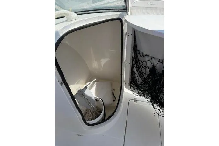 Slide: The Image of Storage compartment on a 2008 Sea Pro 228 Dual Console boat with anchor and rope. - 31