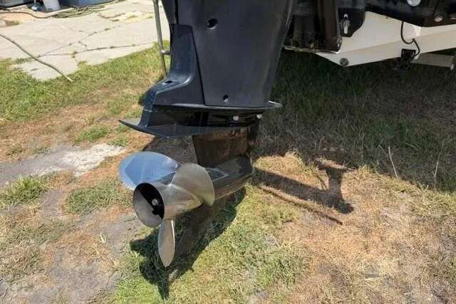 Slide: The Image of 2008 Sea Pro 228 Dual Console boat propeller on grassy ground. - 9