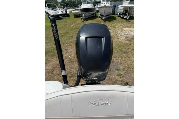 Slide: The Image of 2008 Sea Pro 228 Dual Console boat with outboard motor, parked among other boats. - 24