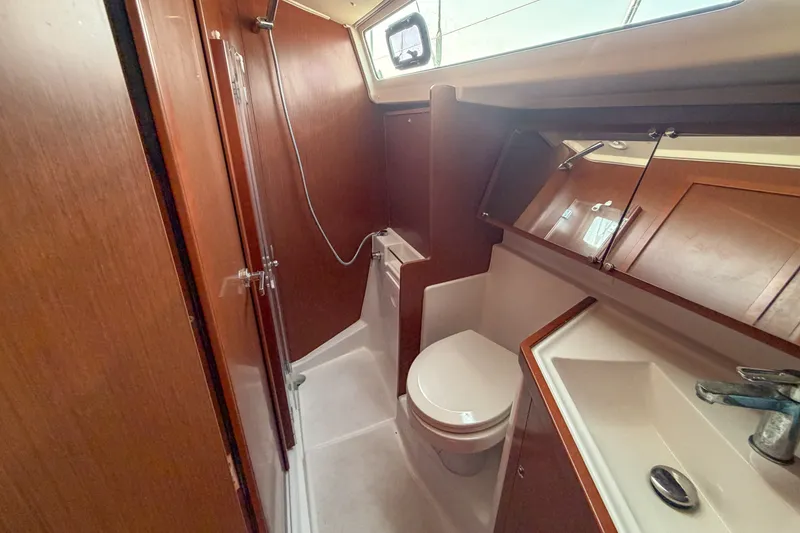 Slide: The Image of 2021 Beneteau Oceanis 41.1 yacht bathroom with shower, sink, and toilet. - 49