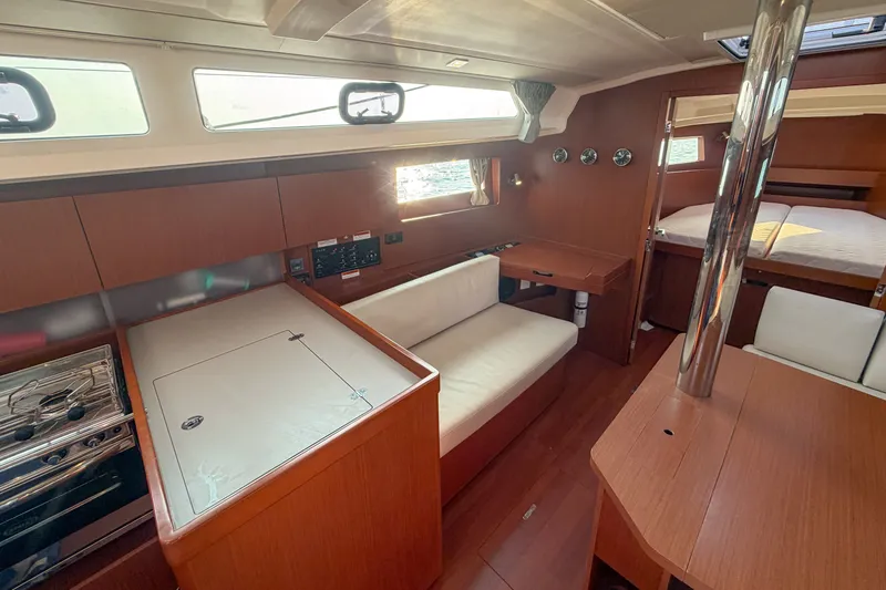 Slide: The Image of Interior of 2021 Beneteau Oceanis 41.1 yacht with modern wood finish and seating area. - 36