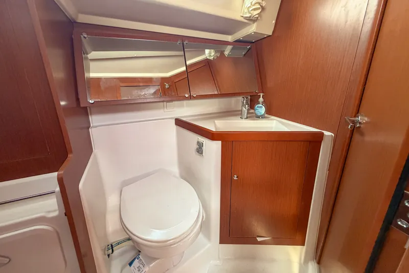 Slide: The Image of 2021 Beneteau Oceanis 41.1 yacht bathroom with wooden cabinetry and modern fixtures. - 48