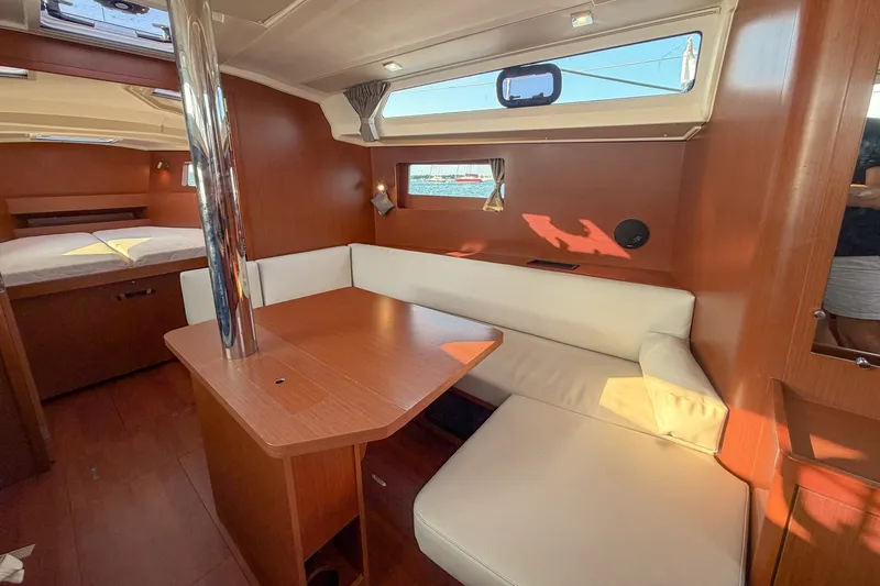 Slide: The Image of Interior of 2021 Beneteau Oceanis 41.1 yacht with cozy seating and wooden finishes. - 34