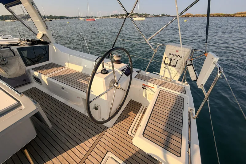 Slide: The Image of Cockpit of 2021 Beneteau Oceanis 41.1 sailboat with wooden deck and steering wheel. - 15
