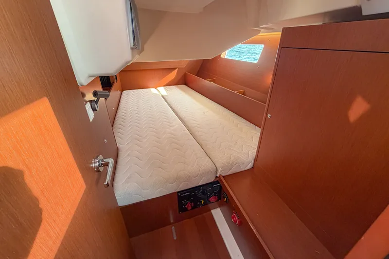 Slide: The Image of Interior cabin of 2021 Beneteau Oceanis 41.1 yacht with cozy bed and wooden finish. - 44