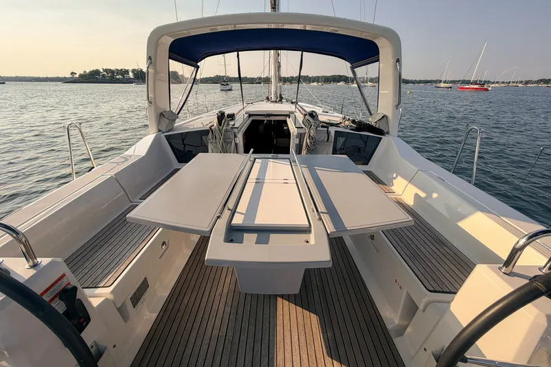 Slide: The Image of Beneteau Oceanis 41.1 yacht cockpit, 2021 model, with spacious seating and table on calm waters. - 13