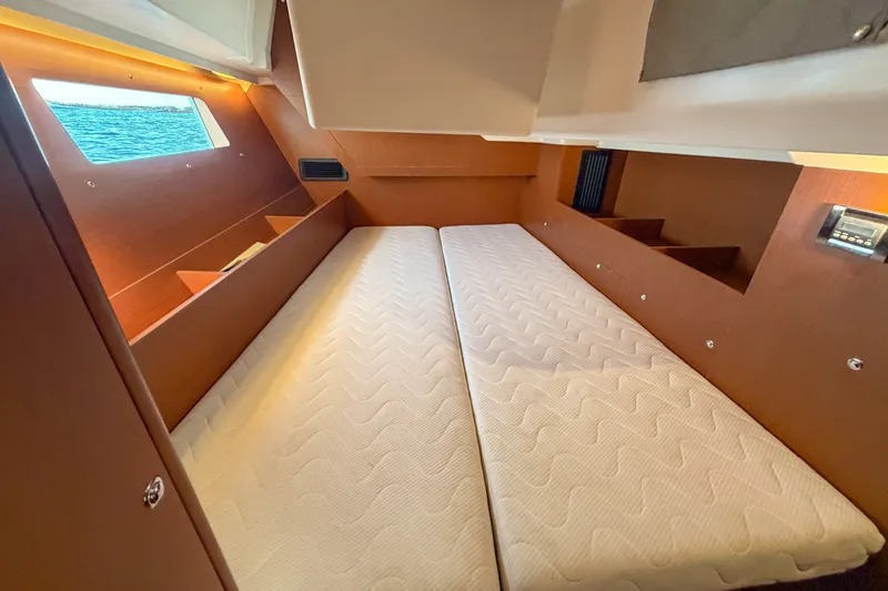 Slide: The Image of Interior cabin of 2021 Beneteau Oceanis 41.1 yacht with twin beds and window view. - 46