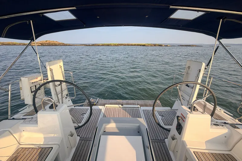 Slide: The Image of Cockpit view of 2021 Beneteau Oceanis 41.1 sailboat on calm waters. - 18