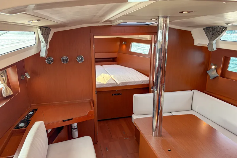 Slide: The Image of Interior of 2021 Beneteau Oceanis 41.1 yacht with wood finish and cozy seating area. - 33