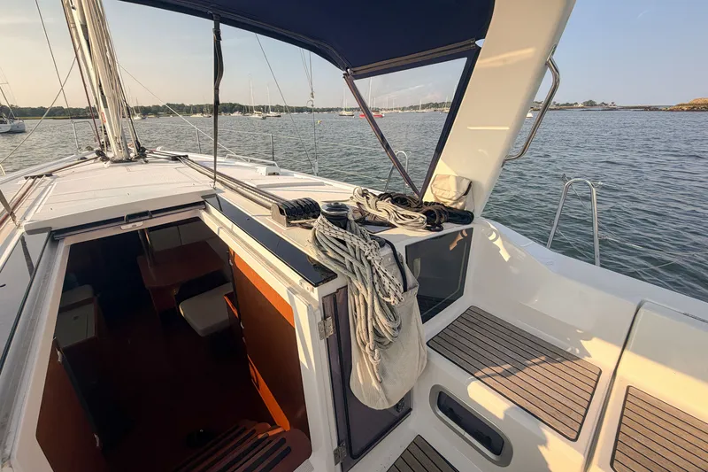 Slide: The Image of Beneteau Oceanis 41.1 sailboat deck and cabin entrance, 2021 model, on calm water. - 24