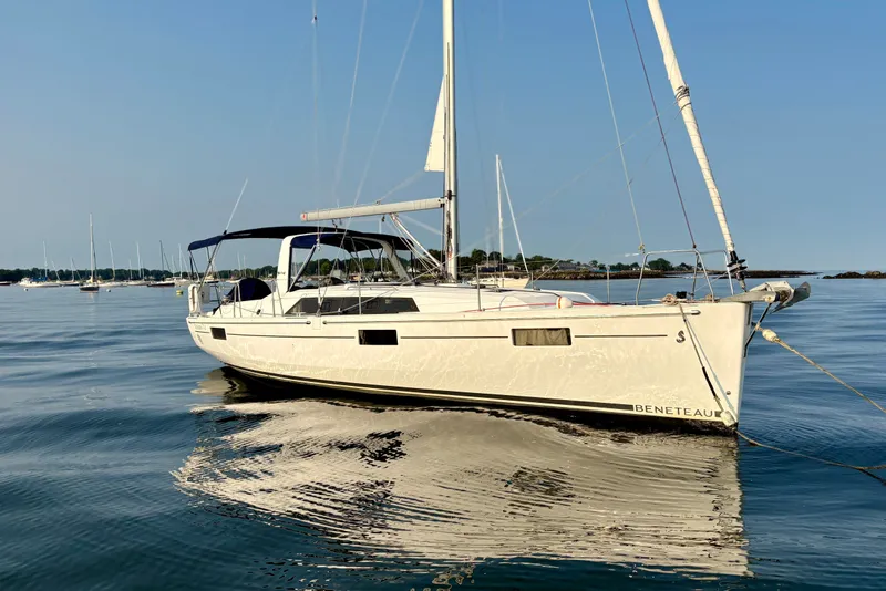 Slide: The Image of 2021 Beneteau Oceanis 41.1 sailboat on calm water, clear sky background. - 6