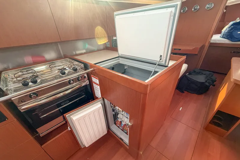 Slide: The Image of Interior of 2021 Beneteau Oceanis 41.1 yacht kitchen with stove and open fridge. - 40