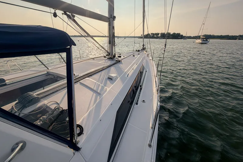 Slide: The Image of 2021 Beneteau Oceanis 41.1 sailboat on calm water at sunset. - 7