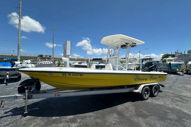 The Image of 2007 Lake & Bay Backwater 24 boat in yellow on trailer, sunny day. - 0