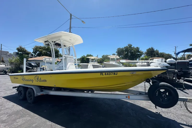Slide: The Image of 2007 Lake & Bay Backwater 24 boat on trailer, yellow hull, sunny day. - 6