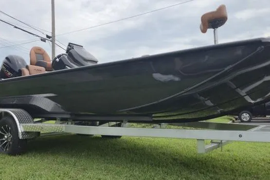 Slide: The Image of 2026 Avid 20 Vertex boat on trailer, sleek design, parked on grass. - 13
