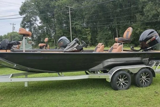 The Image of 2026 Avid 20 Vertex boat on trailer, parked on grass, with trees in background. - 0