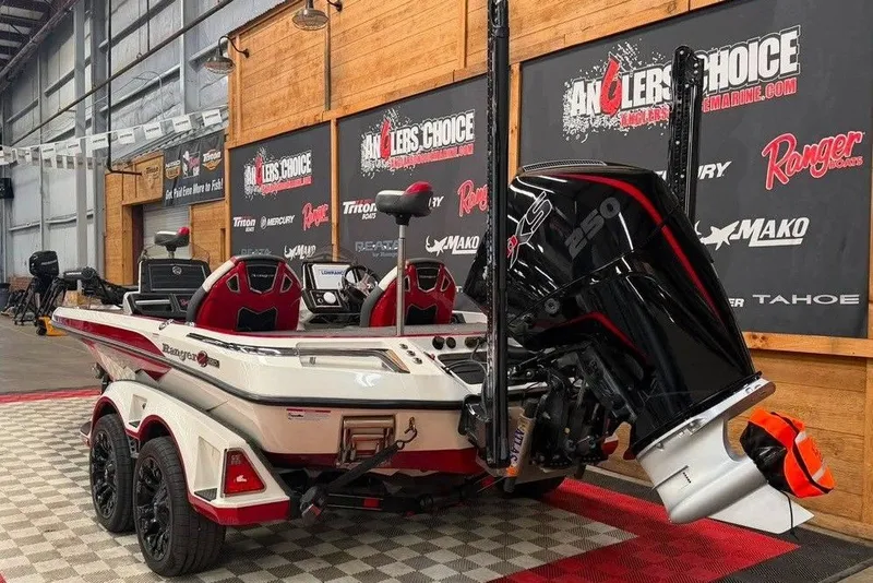 Slide: The Image of 2022 Ranger Z520R boat with powerful engine displayed indoors at Anglers Choice showroom. - 5
