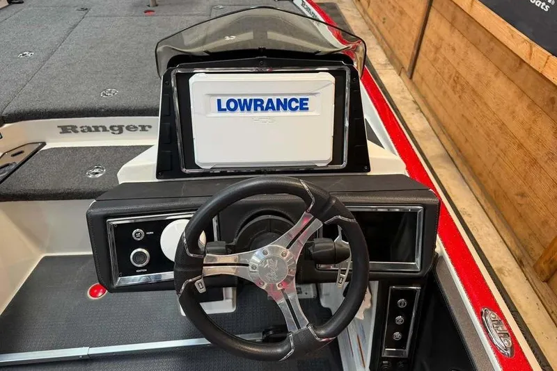 Slide: The Image of 2022 Ranger Z520R boat dashboard with Lowrance display and steering wheel. - 2