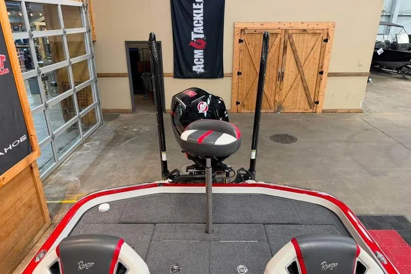 Slide: The Image of 2022 Ranger Z520R boat interior with seating and motor in a showroom. - 8