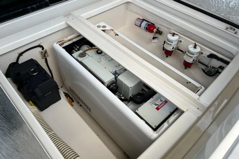 Slide: The Image of Engine compartment of a 2016 Aquila 48 yacht, featuring mechanical components and safety equipment. - 29