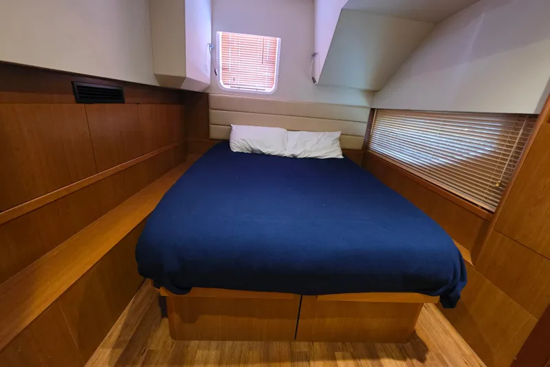 Slide: The Image of Cozy cabin interior of 2016 Aquila 48 yacht with wooden accents and a comfortable bed. - 23