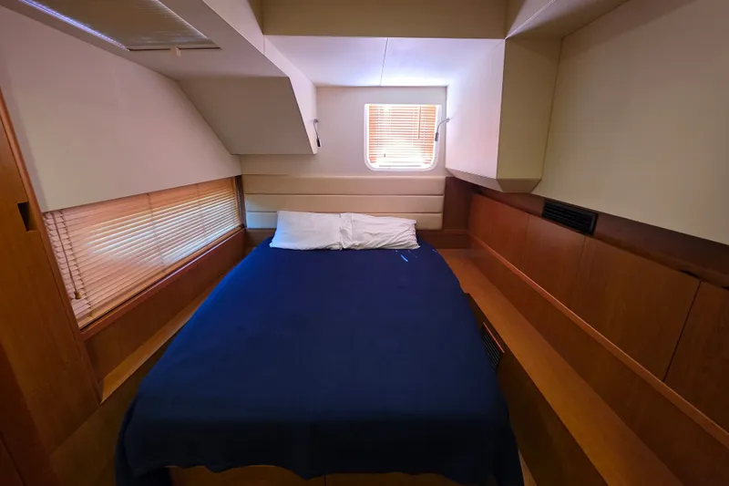 Slide: The Image of Cozy cabin interior of 2016 Aquila 48 yacht with bed and window blinds. - 27