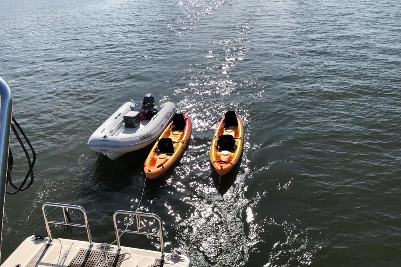 Slide: The Image of Two kayaks and a dinghy floating near an Aquila 48 yacht, 2016 model. - 43