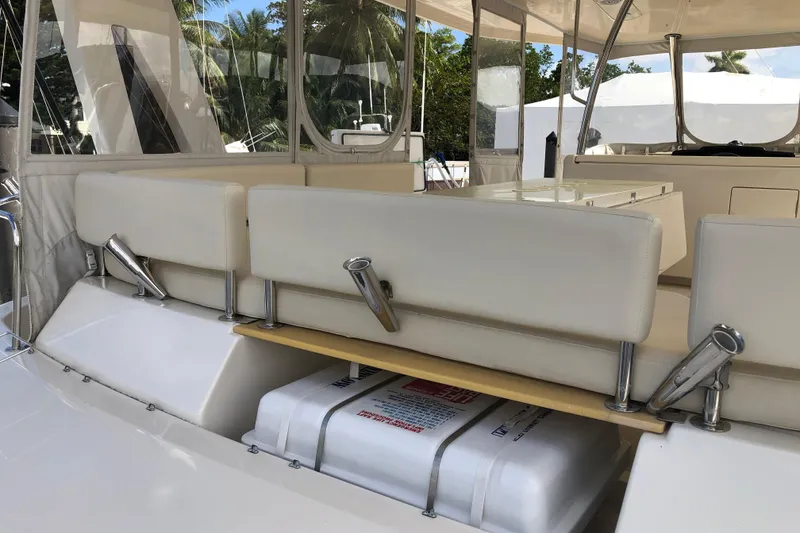 Slide: The Image of Aquila 48 yacht interior, 2016 model, featuring white seating and safety equipment. - 9