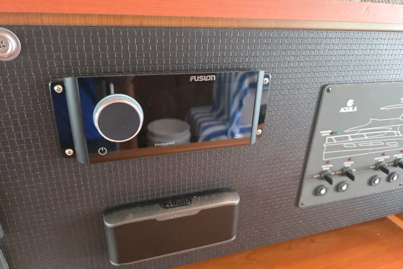 Slide: The Image of Control panel of a 2016 Aquila 48 yacht featuring a Fusion audio system. - 38