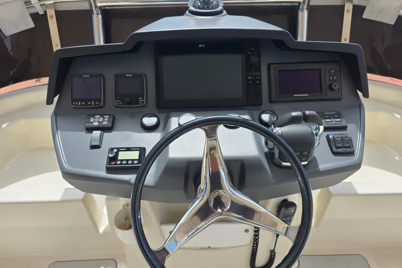 Slide: The Image of Steering console of a 2016 Aquila 48 yacht with navigation controls and displays. - 11