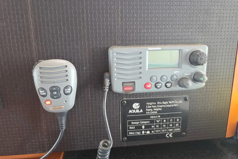Slide: The Image of Marine radio equipment on 2016 Aquila 48 yacht, featuring Raymarine VHF radio and microphone. - 37