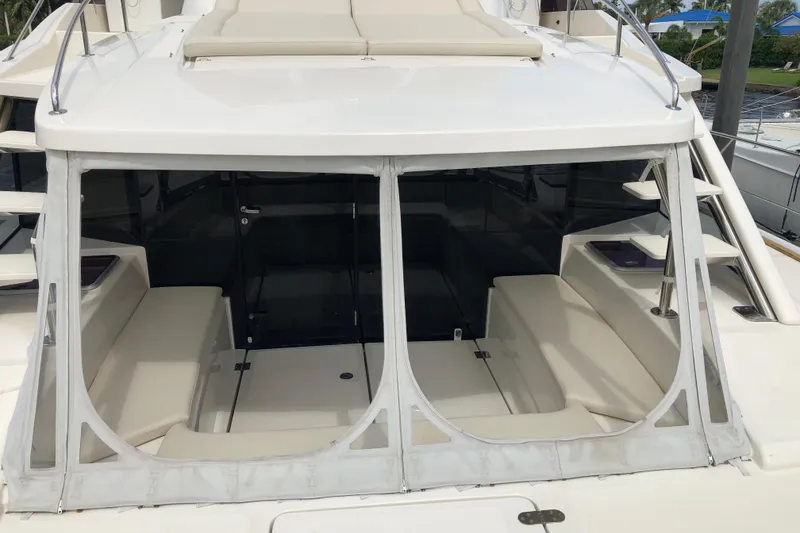 Slide: The Image of 2016 Aquila 48 yacht with enclosed seating area and sleek design. - 5