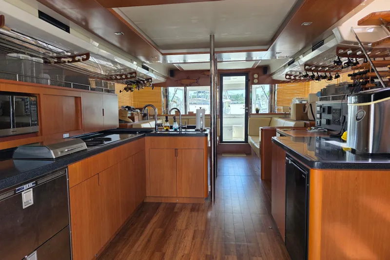 Slide: The Image of Luxurious kitchen interior of a 2016 Aquila 48 yacht with modern appliances and wood finishes. - 16