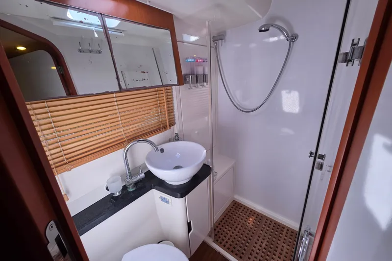 Slide: The Image of Luxurious bathroom in 2016 Aquila 48 yacht with modern fixtures and wooden accents. - 26