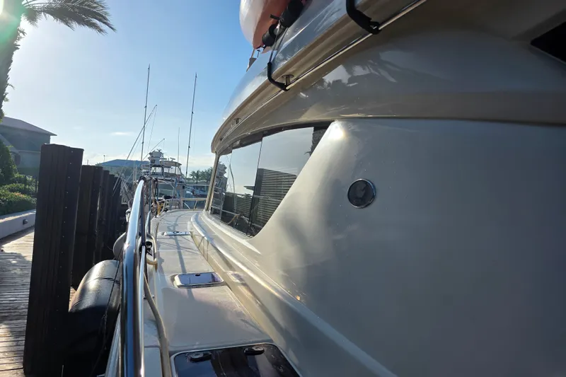 Slide: The Image of Side view of a 2016 Aquila 48 yacht docked under a clear sky. - 3