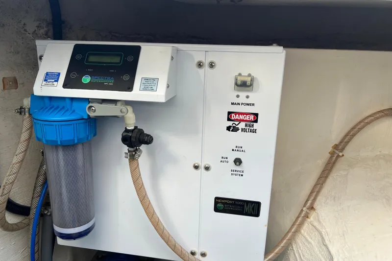 Slide: The Image of Spectra watermaker system in 2016 Aquila 48 yacht, featuring control panel and filter. - 35