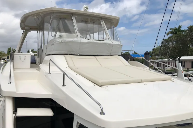 Slide: The Image of 2016 Aquila 48 yacht with spacious deck and modern design, docked under a cloudy sky. - 6