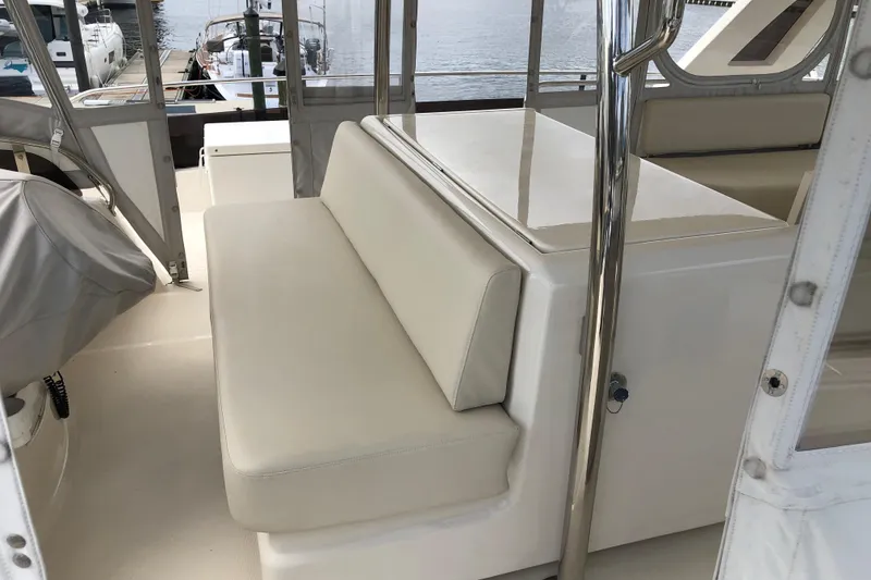 Slide: The Image of Interior seating area of a 2016 Aquila 48 yacht, featuring cream-colored cushions. - 13