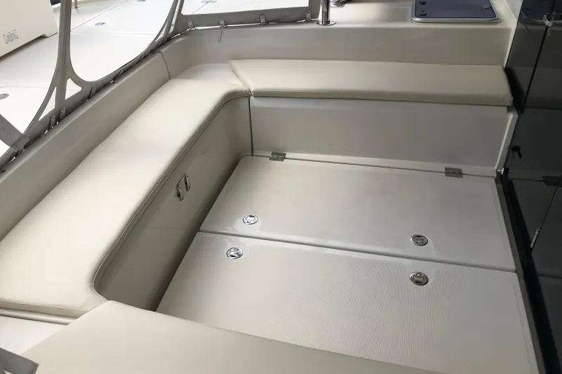 Slide: The Image of Interior seating area of 2016 Aquila 48 yacht, featuring cushioned benches and storage compartments. - 8