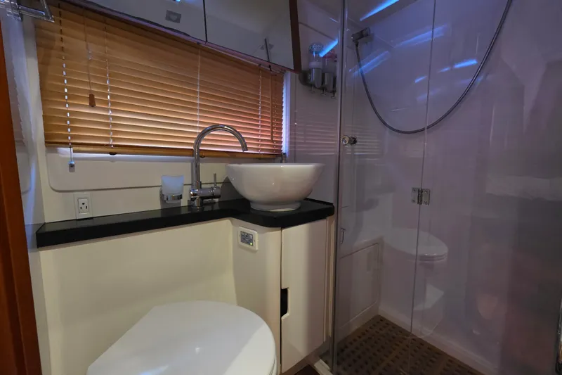 Slide: The Image of Modern bathroom in 2016 Aquila 48 yacht with glass shower and sleek fixtures. - 24