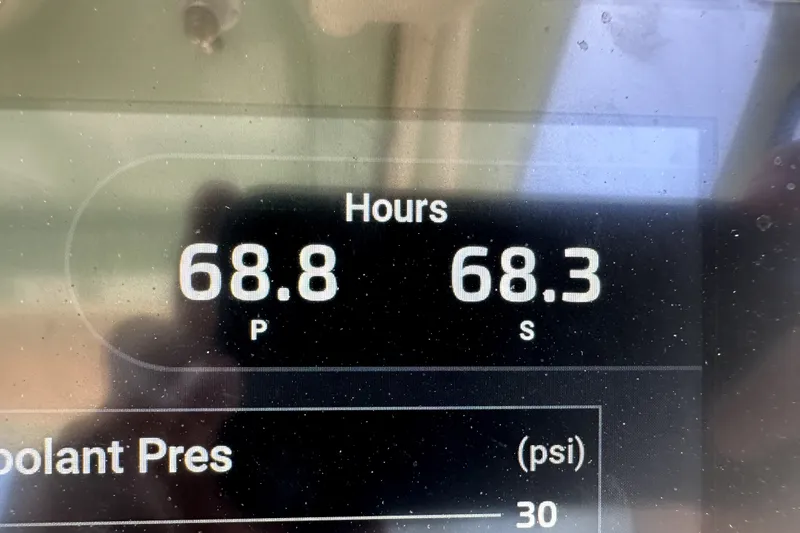 Slide: The Image of Digital display showing engine hours for Grady-White Freedom 275, 2021 model. - 17